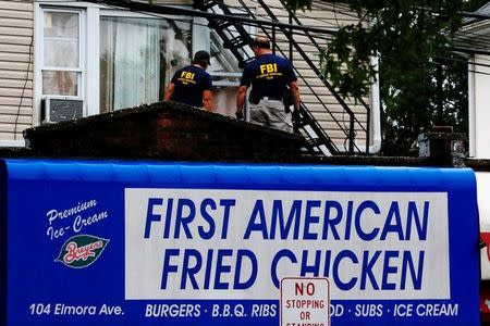 Federal Bureau of Investigation (FBI) personnel search an address during an investigation into Ahmad Khan Rahami, who was wanted for questioning in an explosion in New York, which authorities believe is linked to the explosive devices found in New Jersey, in Elizabeth, U.S., September 19, 2016. REUTERS/Eduardo Munoz