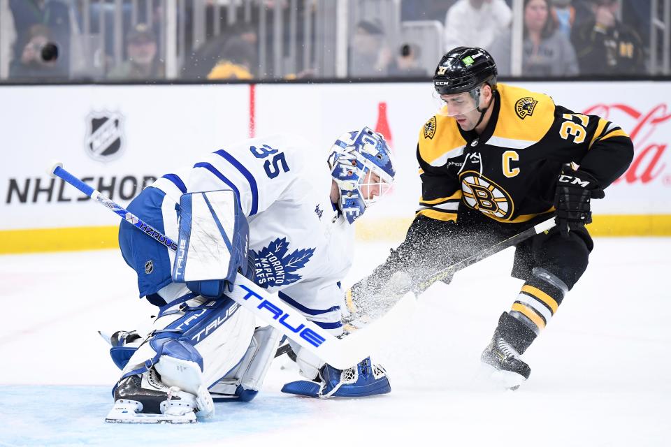 Toronto Maple Leafs goaltender Ilya Samsonov (35) holds up the puck in front of Boston Bruins center Patrice Bergeron (37) during the first period at TD Garden on April 6, 2023.