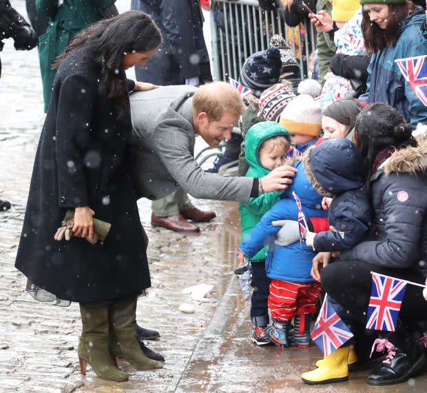 <em>Meghan Markle in a William Vintage, coat Oscar de la Renta dress and Sarah Flint boots in Bristol, England. Photo: Chris Jackson/Getty Images</em>