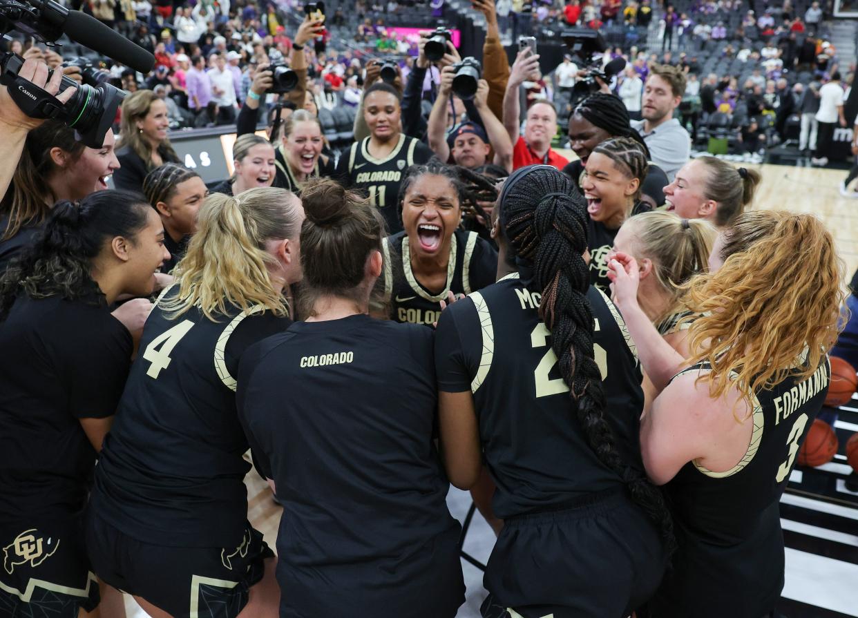 The Colorado Buffaloes celebrate their 92-78 victory over the LSU Tigers Monday night in the Naismith Basketball Hall of Fame Series at T-Mobile Arena in Las Vegas.