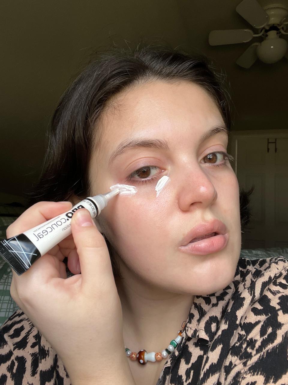 Gabi applying the white concealer to her under eyes