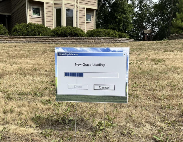 A "New Grass Loading" sign on dry-looking grass with the computer loading bar and "Done" or "Cancel" fields
