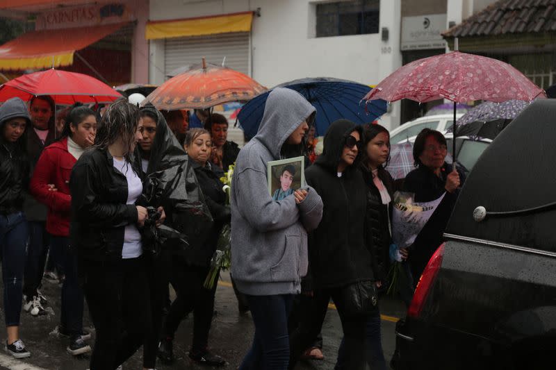 People attend the funeral of several of the victims killed by shooters at a slot-machine arcade in the central Mexican state of Michoacan, in Uruapan