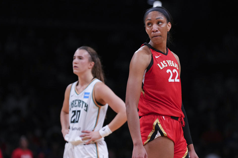 A'ja Wilson of the Las Vegas Aces looks on along with Sabrina Ionescu of the New York Liberty at Barclays Center on July 12, 2022 in the Brooklyn borough of New York City. The Las Vegas Aces defeated the New York Liberty 107-101.