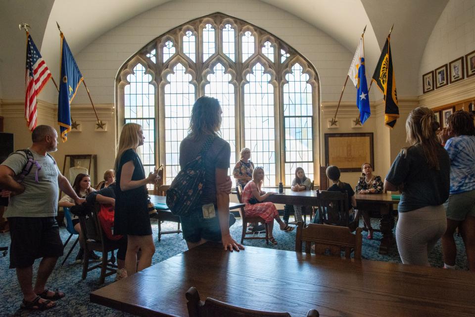 Ending their tour inside the Hall of Fame room at Topeka High School, Ukrainian students and their parents ask questions to former students as part of a tour before starting the school year later this week.