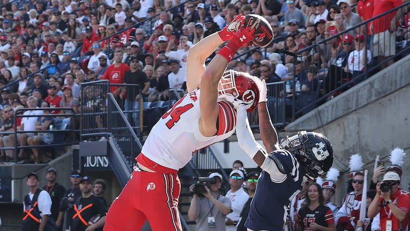 Utah Utes tight end Caleb Lohner (84) scores against Utah State Aggies cornerback JD Drew (3)  in Logan on Saturday, Sept. 14, 2024.