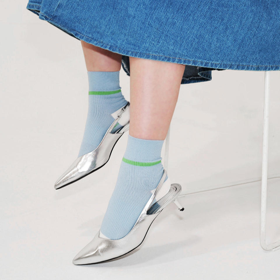 Footwear News Shop editor Olivia Cigliano wearing Bombas blue ankle socks and silver kitten heels
