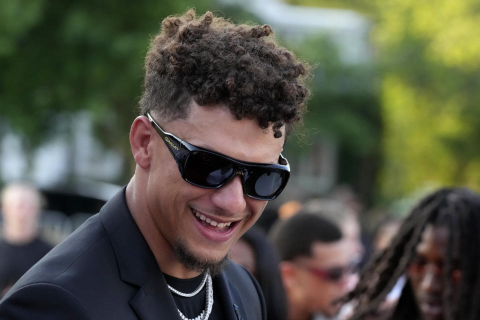 Kansas City Chiefs quarterback Patrick Mahomes arrives on the red carpet before a ceremony for team members to receive their championship rings for winning NFL's Super Bowl 58 football game Thursday, June 13, 2024, in Kansas City, Mo. (AP Photo/Charlie Riedel)