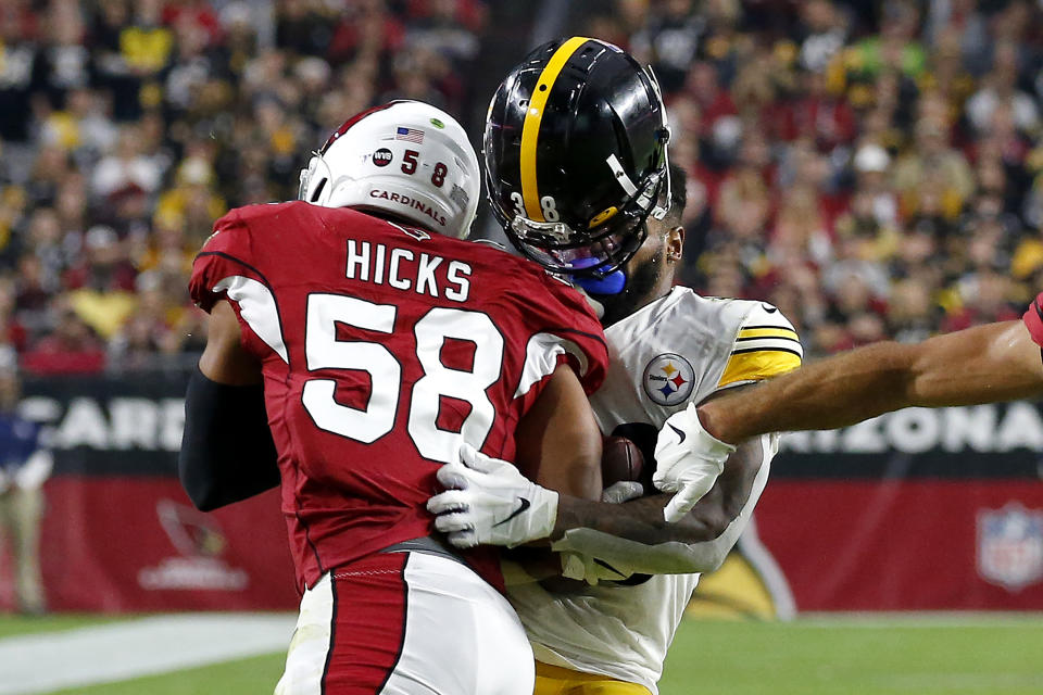 Arizona Cardinals middle linebacker Jordan Hicks (58) knocks the helmet off Pittsburgh Steelers running back Jaylen Samuels on the tackle during the first half of an NFL football game, Sunday, Dec. 8, 2019, in Glendale, Ariz. (AP Photo/Ross D. Franklin)