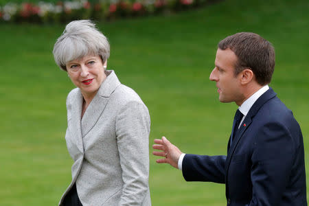 FILE PHOTO: French President Emmanuel Macron (R) escorts Britain's Prime Minister Theresa May after they spoke to the press at the Elysee Palace in Paris, France, June 13, 2017. REUTERS/Philippe Wojazer/File Photo