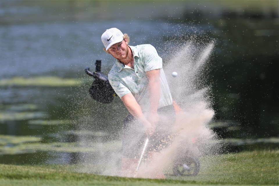 Yorktown senior Gabe Reedy hits his ball out of the 18th-hole bunker in the IHSAA Muncie Central boys golf regional tournament at The Players Club on Thursday, June 8, 2023.