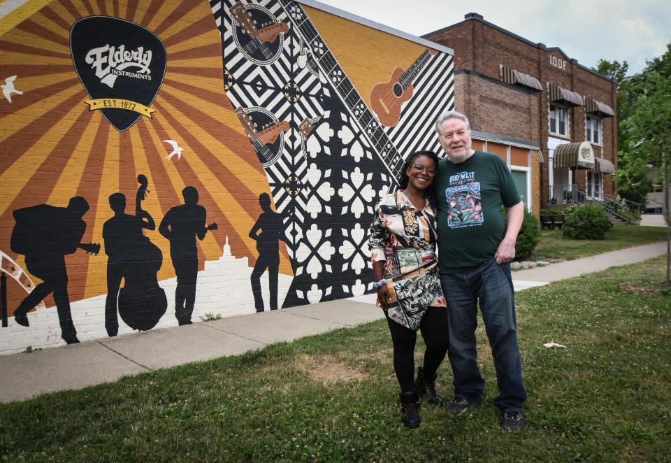 Elderly Instruments CEO and co-founder Stan Werbin, 75, and daughter Lillian, 31, the president of the company, or as her business card reads: "Stan's Right Hand," pictured Friday, July 1, 2022, in front of their new, used, and vintage musical instrument store. Elderly celebrates 50 years in Lansing on July 5.