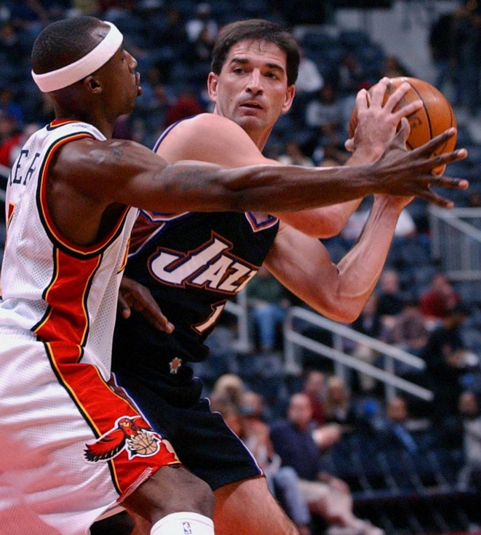 Utah Jazz’s John Stockton (12) , right, looks for a teammate under pressure from Atlanta Hawks’ Jason Terry (31) during first quarter action, Thursday, Oct. 31, 2002, at Philips Arena in Atlanta.