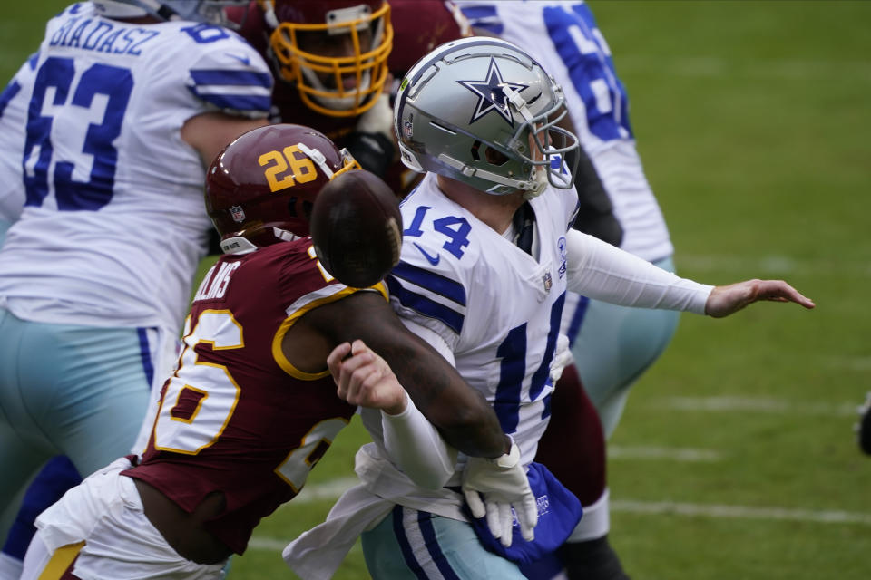 Washington Football Team strong safety Landon Collins (26) knocks the ball of the hands of Dallas Cowboys quarterback Andy Dalton (14) during the first half of an NFL football game, Sunday, Oct. 25, 2020, in Landover, Md. (AP Photo/Susan Walsh)