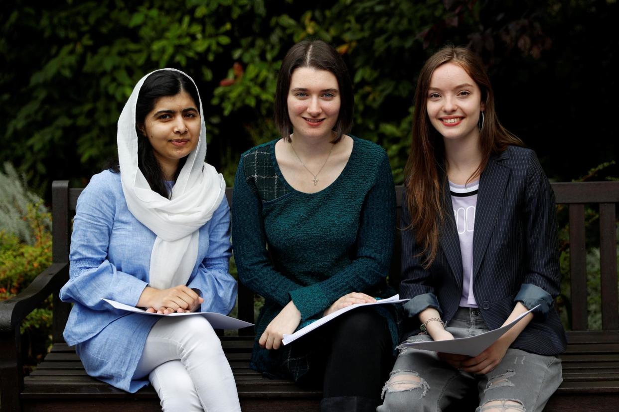 Malala Yousafzai poses with fellow students Bethany Lucas and Beatrice Kessedjian after collecting her A level exam results at Edgbaston High School for Girls in Birmingham: REUTERS