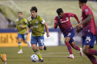 Seattle Sounders midfielder Nicolas Lodeiro (10) moves with the ball during the second half of the team's MLS playoff soccer match against FC Dallas, Tuesday, Dec. 1, 2020, in Seattle. (AP Photo/Ted S. Warren)