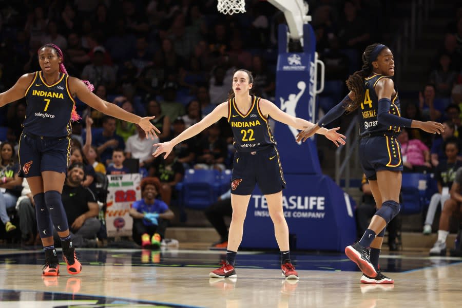 ARLINGTON, TEXAS – MAY 03: Caitlin Clark #22 of the Indiana Fever celebrates a first half three pointer with Allya Boston #7 and Tami Fagbenle #14 while playing the Dallas Wings at College Park Center on May 03, 2024 in Arlington, Texas. (Photo by Gregory Shamus/Getty Images)