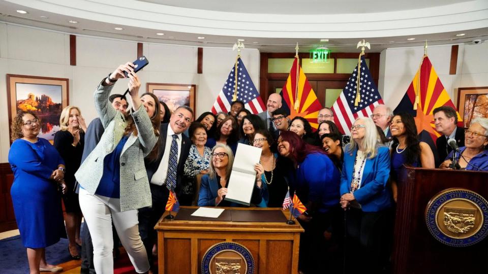 PHOTO: Arizona Gov. Katie Hobbs holds the bill she signed, repealing the state's near total abortion ban that dates to 1864, during a news conference at the Governor's Office, May 2, 2024.  (Rob Schumacher/The Republic / USA TODAY NETWORK)