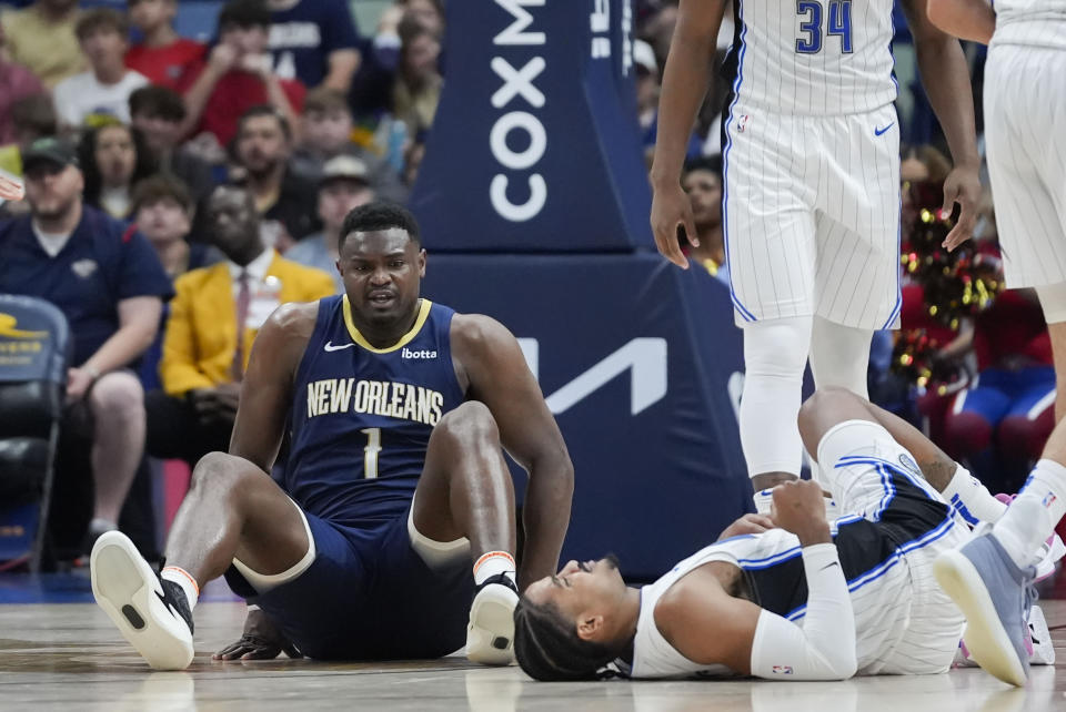 New Orleans Pelicans forward Zion Williamson (1) gets up off the court after colliding with Orlando Magic guard Gary Harris in the second half of an NBA basketball game in New Orleans, Wednesday, April 3, 2024. The Magic won 117-108. (AP Photo/Gerald Herbert)