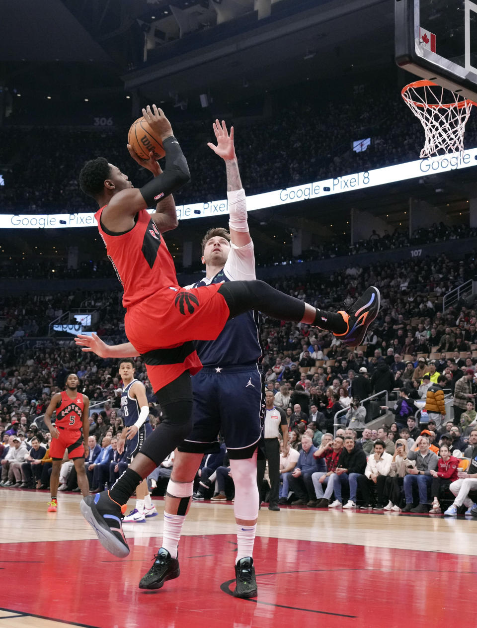 Toronto Raptors' RJ Barrett shoots over Dallas Mavericks' Luka Doncic during the first half of an NBA basketball game in Toronto on Wednesday, Feb. 28, 2024. (Chris Young/The Canadian Press via AP)