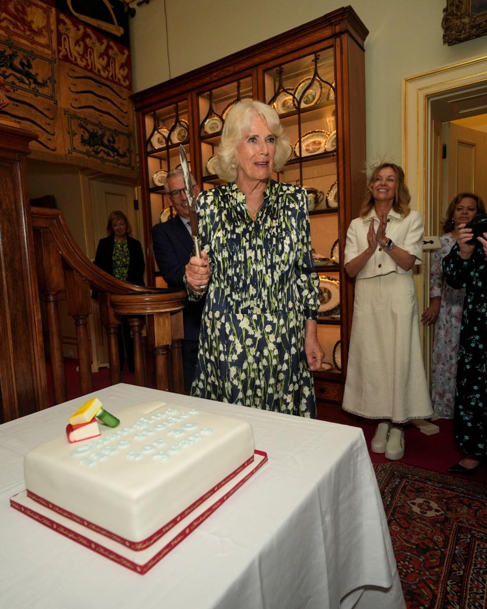 LONDON, ENGLAND - JULY 9: Queen Camilla cuts a cake to celebrate the National Literacy Trust charity's 30th anniversary at Clarence House on July 9, 2024 in London, England. (Photo by Yui Mok - WPA Pool/Getty Images)