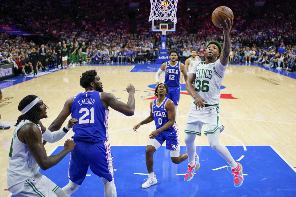 Boston Celtics' Marcus Smart (36) shoots as Philadelphia 76ers' Joel Embiid (21) watches during the first half of Game 6 of an NBA basketball playoffs Eastern Conference semifinal, Thursday, May 11, 2023, in Philadelphia. (AP Photo/Matt Slocum)