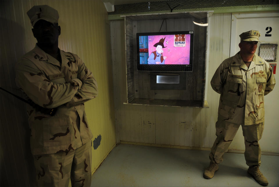 GUANTANAMO BAY, CUBA - DECEMBER 10: An image reviewed by the U.S. military shows guards in the movie room at the "Camp Four" detention facility during a visit by journalists December 10, 2008 on U.S. Naval Station Guantanamo Bay, Cuba. Camp Four houses the most compliant detainees where they live in a more open, community oriented manner. National Geographic programs and cartoons are popular with detainees. (Photo by Mandel Ngan-Pool/Getty Images)