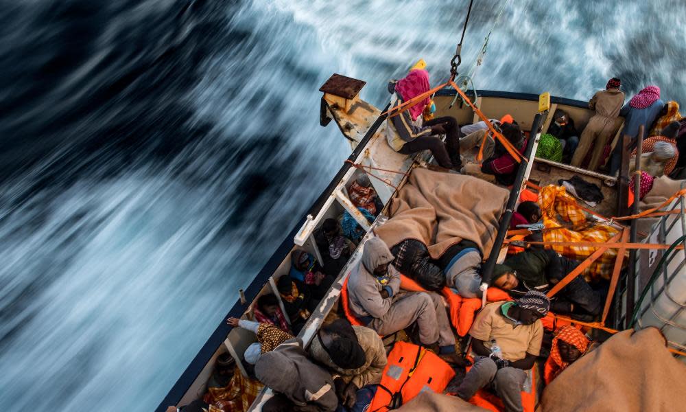 Asylum seekers sleep on the deck of a Spanish vessel after being rescued off the Libyan coast.