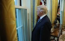 U.S. President Donald Trump looks out a window of the Oval Office following an interview with Reuters at the White House in Washington, U.S., April 27, 2017. REUTERS/Carlos Barria