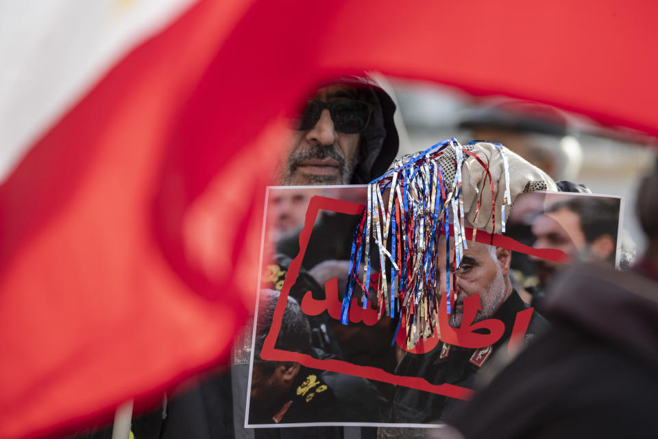 Supporters of the Mujahedeen-e-Khalq, or the MEK, an Iranian exile group, hold signs and flags during a show of support for a U.S. airstrike in Iraq that killed Iranian Gen. Qassem Soleimani, in Lafayette Park across from the White House, Sunday, Jan. 5, 2020, in Washington. (AP Photo/Alex Brandon)