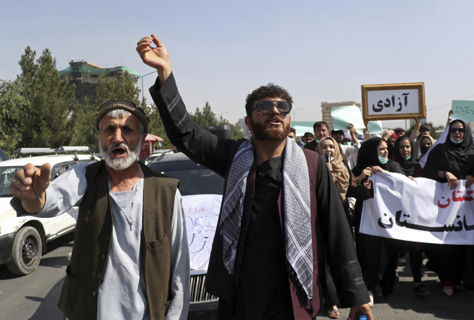 Afghas shout slogans during an anti-Pakistan demonstration, near the Pakistan embassy in Kabul, Afghanistan, Tuesday, Sept. 7, 2021. The framed sign in Persian reads, "Freedom." (AP Photo/Wali Sabawoon)