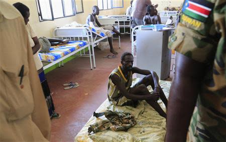 A wounded South Sudan military personnel rests on a mattress on the floor as he undergoes medical treatment at the general military hospital in the capital Juba December 28, 2013. REUTERS/James Akena