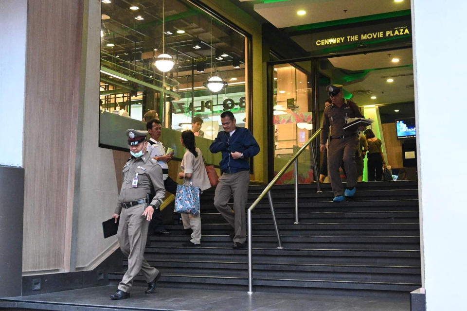 Members of the Thai Royal Police walk out of the Century Plaza mall Tuesday, Feb. 18, 2020 in Bangkok, Thailand. Gun violence has struck again at a shopping mall in Thailand, where a man in the nation's capital Bangkok shot dead one woman working in a beauty clinic and wounded another. (AP Photo)