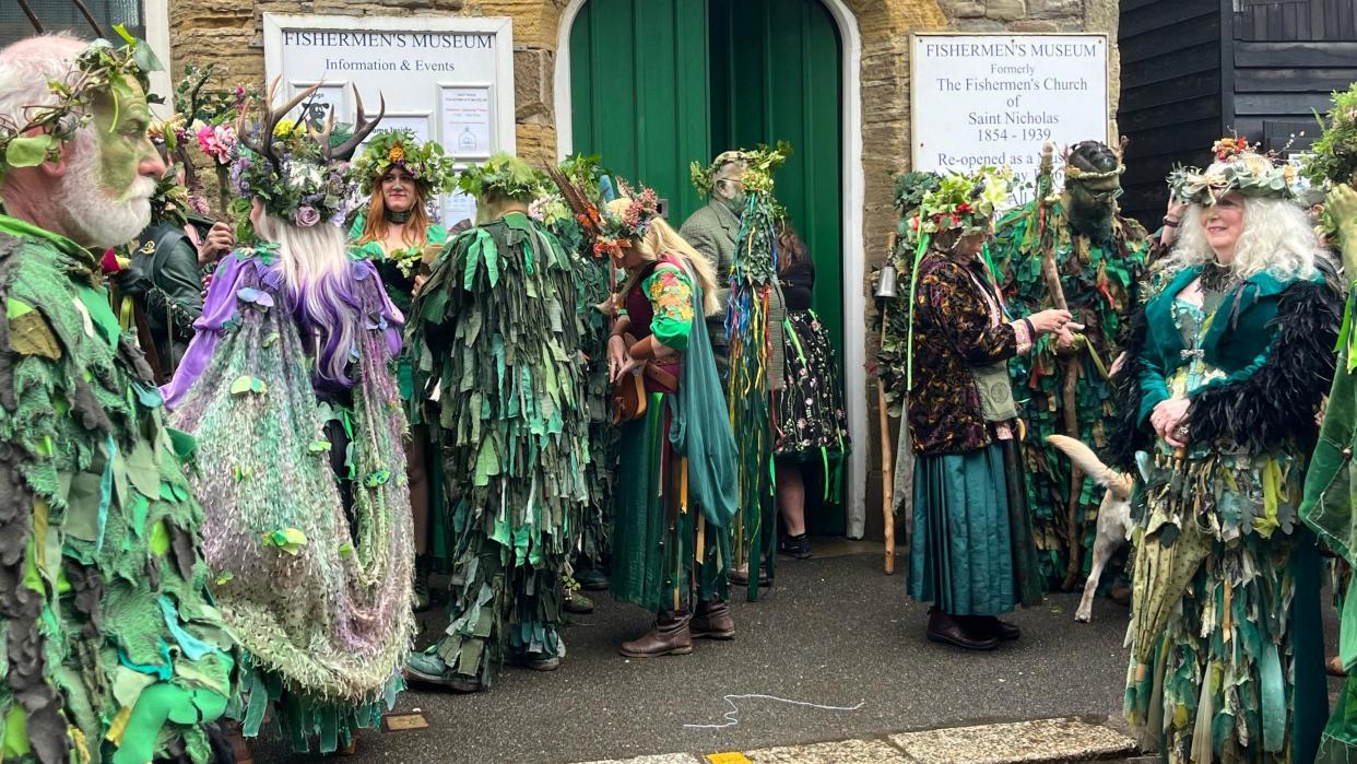 A crowd of people all dressed in costumes in shades of green to mark the Jack in the Green festival 