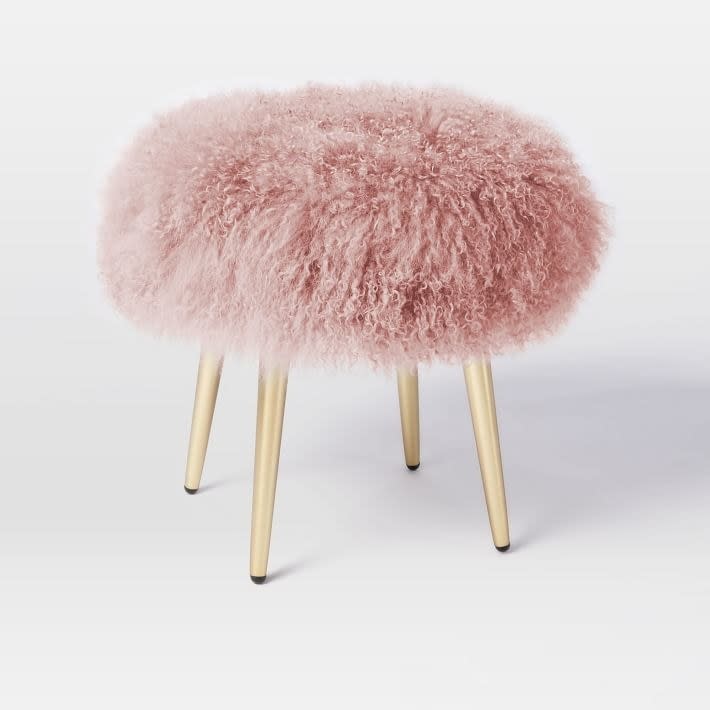 This stool is begging you to put your feet up and stay a while. <a rel="nofollow noopener" href="https://www.westelm.com/products/mongolian-lamb-stool-h1660/" target="_blank" data-ylk="slk:SHOP NOW;elm:context_link;itc:0;sec:content-canvas" class="link ">SHOP NOW</a>: Mongolian Lamb Stool in Rosette by West Elm, $280 $399 , westelm.com