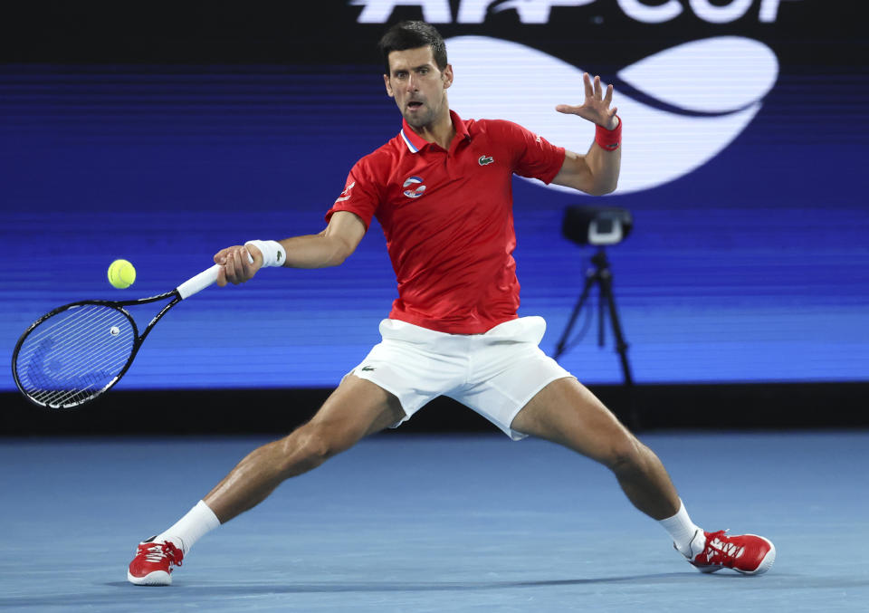 Serbia's Novak Djokovic makes a forehand return to Germany's Alexander Zverev during their ATP Cup match in Melbourne, Australia, Friday, Feb. 5, 2021.(AP Photo/Hamish Blair)