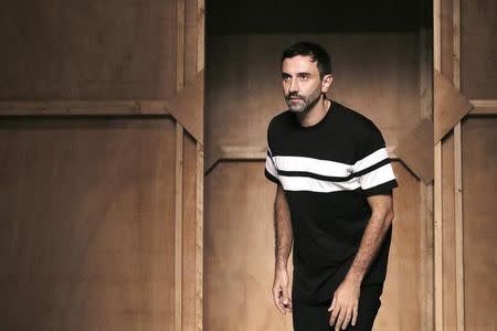 Italian designer Riccardo Tisci appears at the end of his Spring/Summer 2015 women's ready-to-wear collection for fashion house Givenchy during Paris Fashion Week September 28, 2014. REUTERS/Gonzalo Fuentes/File Photo