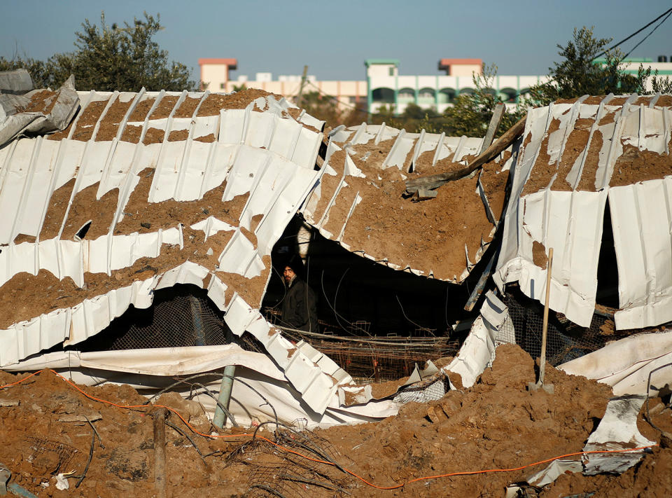 Palestinian inspects scene of Israeli airstrike