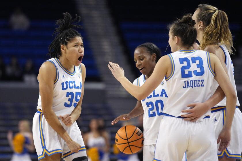 UCLA guard Camryn Brown, left, celebrates with teammates guard Charisma Osborne.