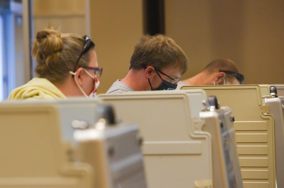 Voters fill out ballots behind privacy screens in 2020 at the Sioux Falls School District Instructional Planning Center.