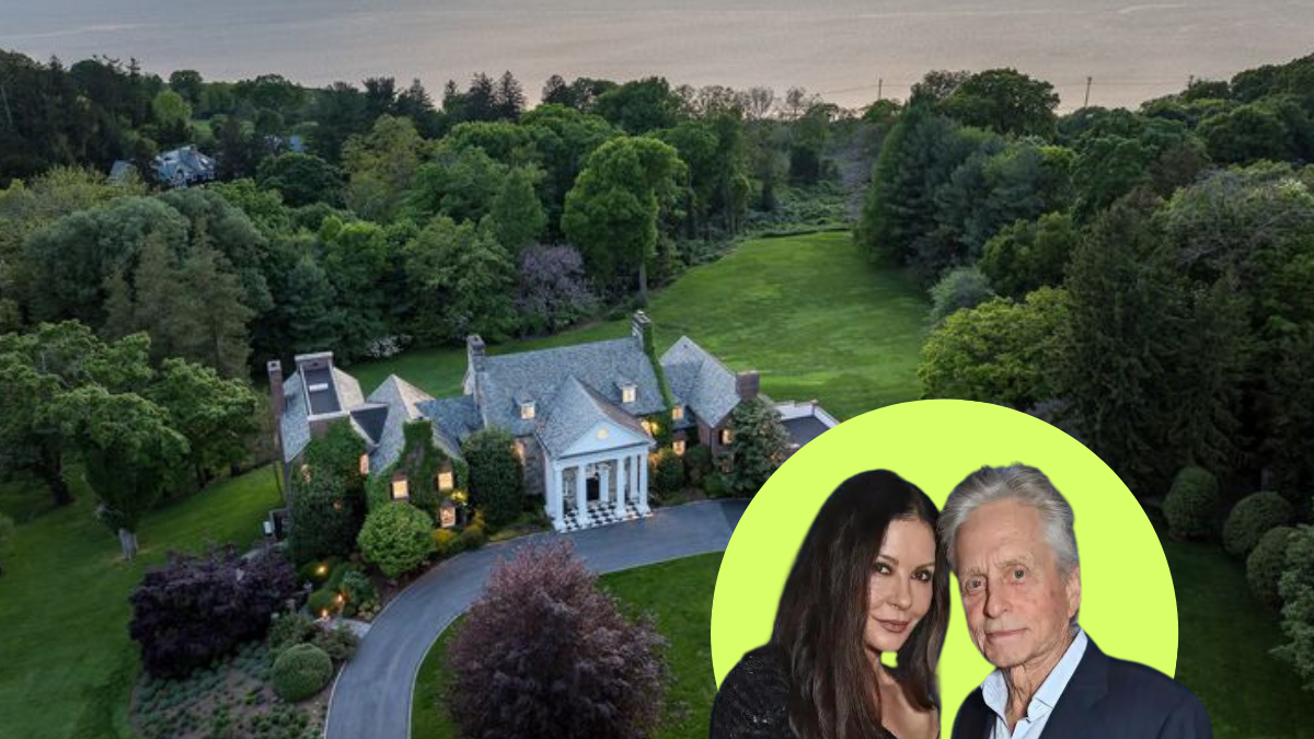 a man and woman standing in front of a house with a large lawn and trees in the background