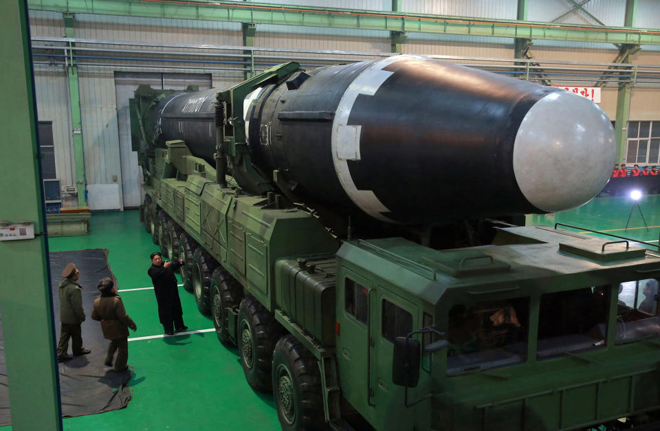 North Korean leader Kim Jong-un (third from left) with a Hwasong-15 intercontinental ballistic missile. Source: AAP