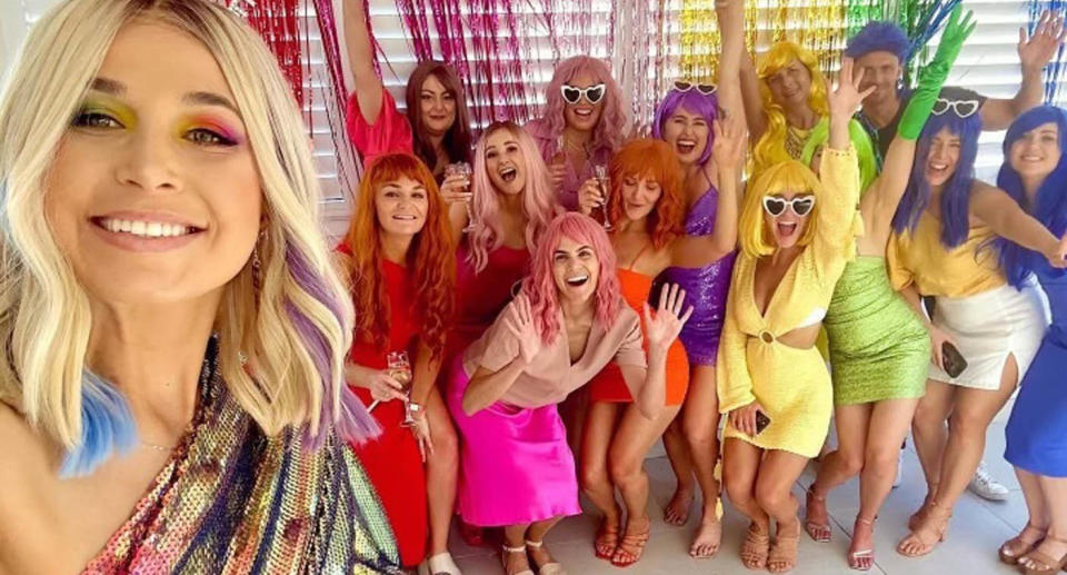 Hannah and friends in colourful outfits and wigs during Sydney hens party. 