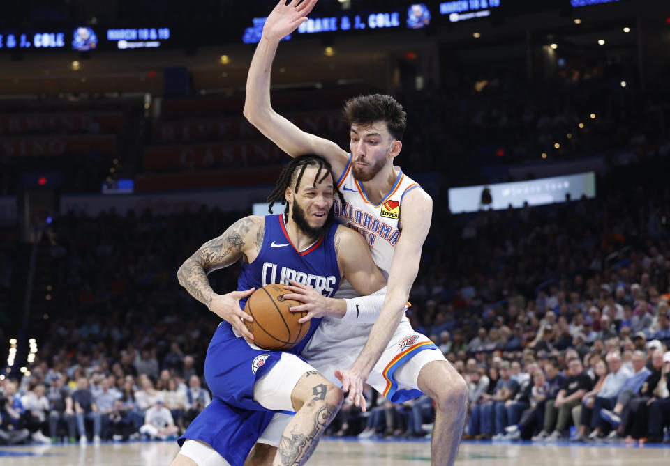 Feb 22, 2024; Oklahoma City, Oklahoma, USA; LA Clippers guard Amir Coffey (7) drives to the basket against Oklahoma City Thunder forward Chet Holmgren (7) during the second half at Paycom Center. Mandatory Credit: Alonzo Adams-USA TODAY Sports