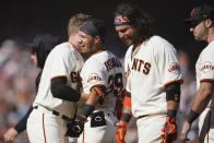 San Francisco Giants' Thairo Estrada, middle left, celebrates with teammates after hitting a two-run home run against the Pittsburgh Pirates during the ninth inning of a baseball game in San Francisco, Sunday, Aug. 14, 2022. (AP Photo/Jeff Chiu)