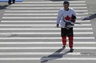 Canada's men's ice hockey team player Patrice Bergeron walks back to Bolshoy Arena after their team practice at the 2014 Sochi Winter Olympics, February 20, 2014. REUTERS/Jim Young (RUSSIA - Tags: SPORT OLYMPICS ICE HOCKEY)