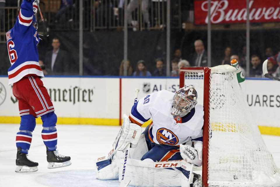 New York Rangers center Ryan Strome, left, celebrates as New York Islanders goaltender Semyon Varlamov (40) reacts after allowing a goal to Rangers defenseman Adam Fox during the second period of an NHL hockey game, Monday, Jan. 13, 2020, in New York. (AP Photo/Kathy Willens)