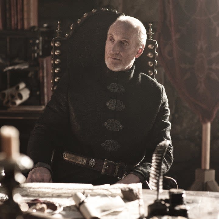 Charles Dance sits in a chair