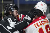 Los Angeles Kings defenseman Drew Doughty, left, and Calgary Flames left wing Matthew Tkachuk scuffle during the first period of an NHL hockey game Thursday, Dec. 2, 2021, in Los Angeles. (AP Photo/Mark J. Terrill)