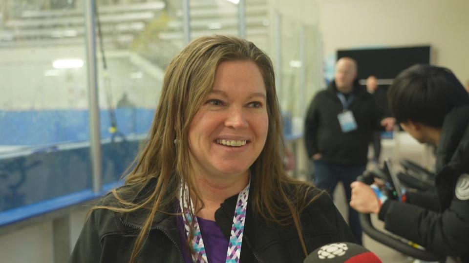 Candance Boechler, a volunteer announcer, is excited to watch her son compete in speed skating.